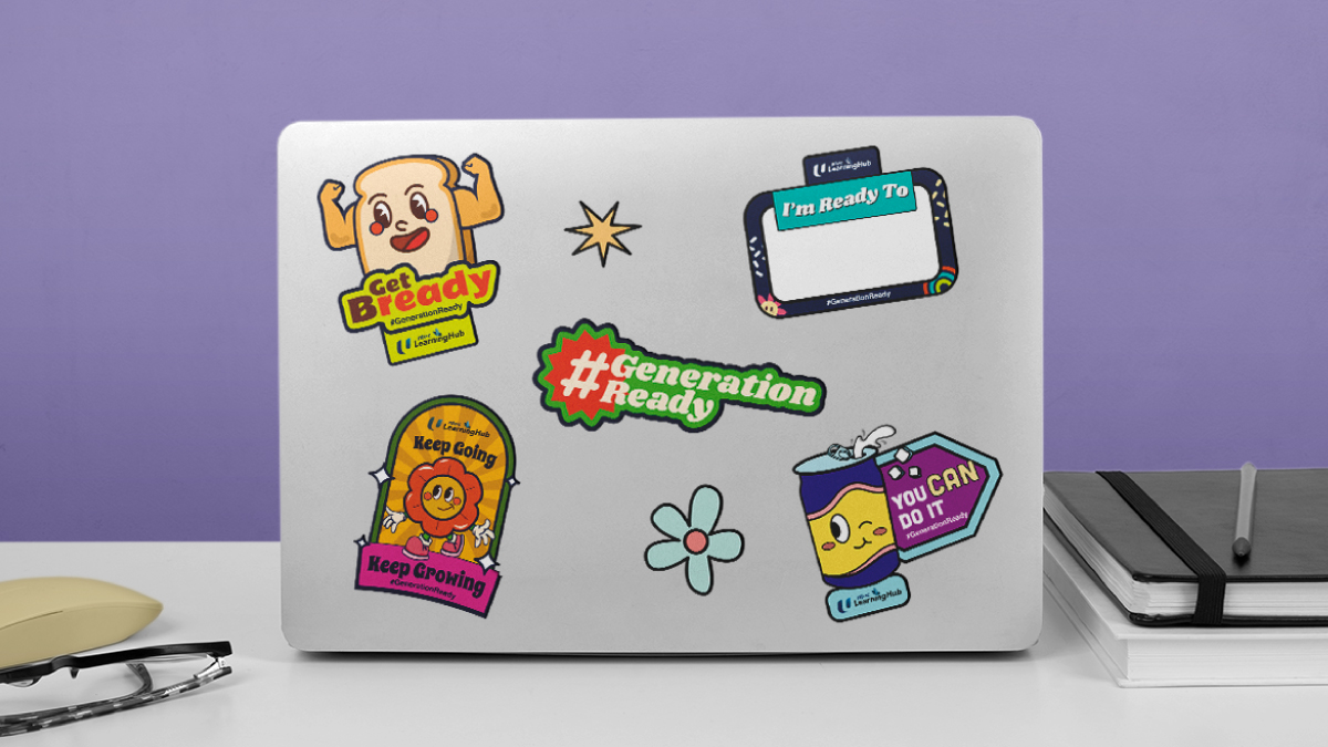 Laptop decorated with colorful stickers featuring messages like 'Get Bready,' '#GenerationReady,' and 'You Can Do It,' showcasing creative brand engagement through unique and visually appealing designs that encourage motivation and participation.