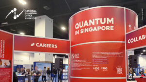 Bold red trade show booth design for Singapore's National Quantum Office (NQO) at APS Global Physics Summit 2026, featuring quantum sector messaging and Singapore branding on a large exhibit display.